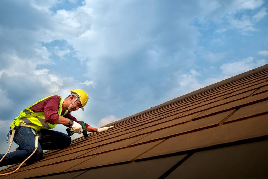 Roofing expert carrying shingles
